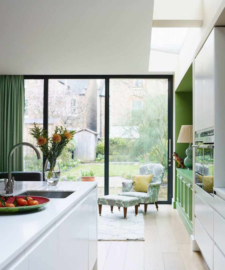 View between the kitchen island and units towards the bi-fold doors to the garden with skylights overhead