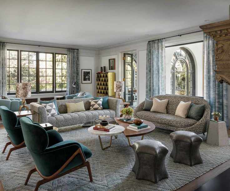 living room with two white sofas and blue chairs with windows all round