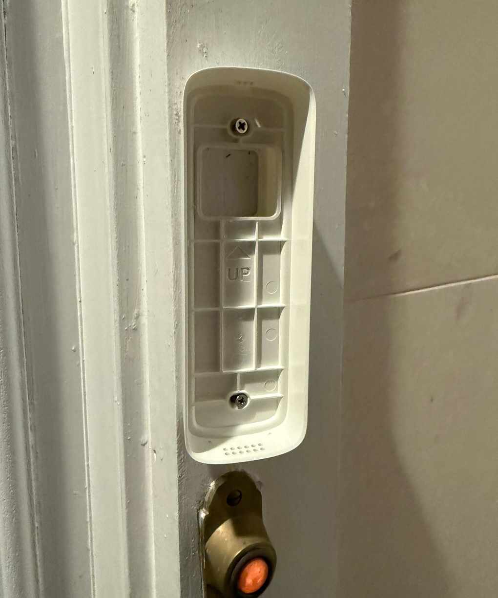 Baseplate of Lorex 2K WI-FI Video Doorbell is installed on doorframe.