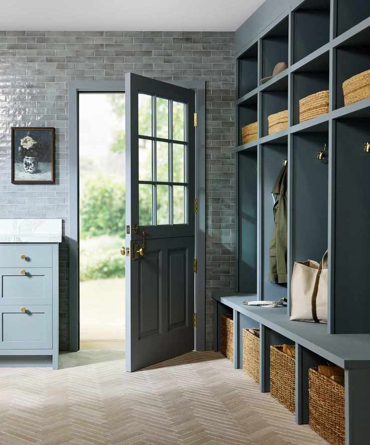 A blue mudroom designed by Shea McGee with Ann Sacks