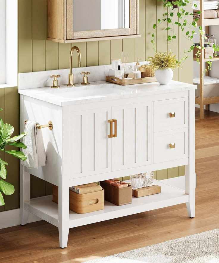A green paneled bathroom with a white vanity and gold hardware