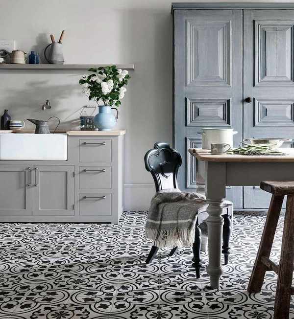 farmhouse kitchen with blue cabinets and patterned tile floor
