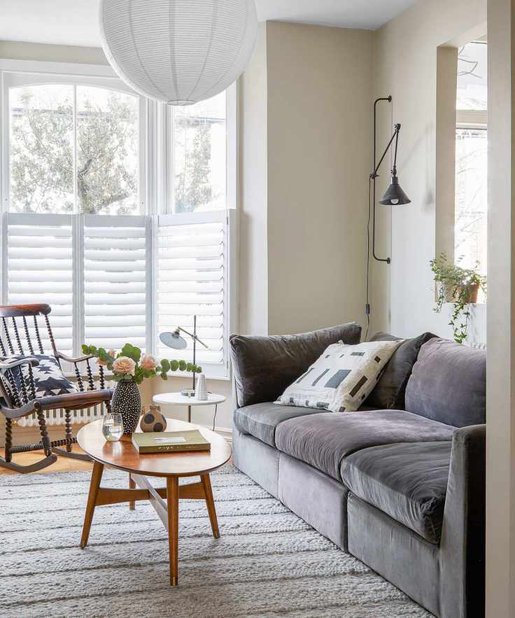 Scandinavian living room design with grey sofa and white wall