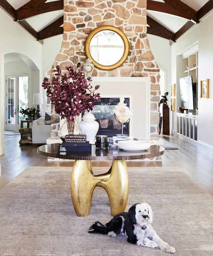 Modern rustic home with round table and stone fireplace
