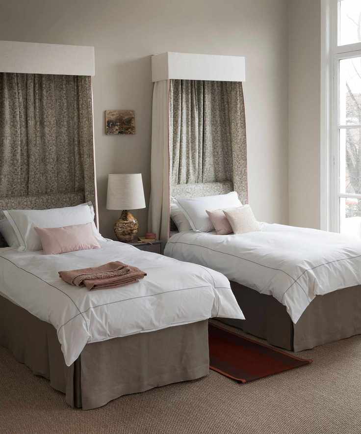 An example of bed ideas showing twin beds with canopies and white bedding