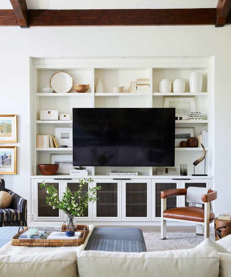 Warm white living room with dark wood accents and display unit