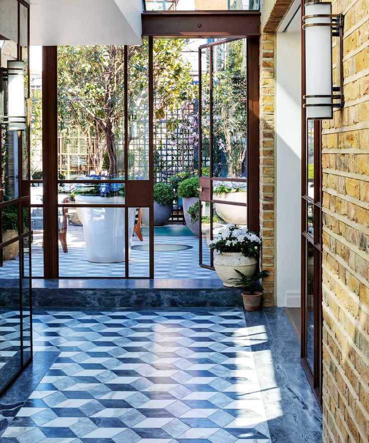 Modern entryway with tiled flooring and glass doors