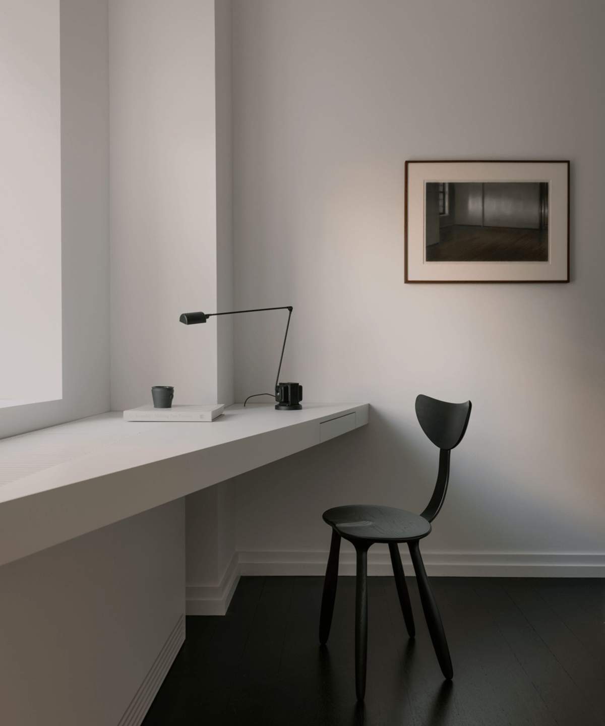 Minimal desk with black chair, black desk lamp and desk