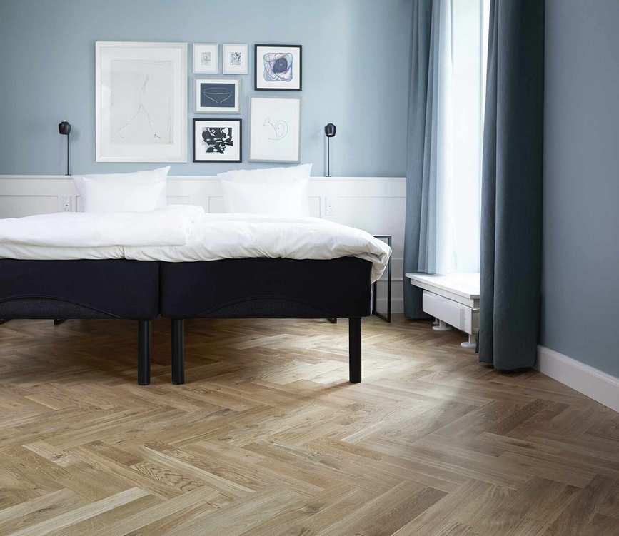 Chevron parquet flooring in a bedroom