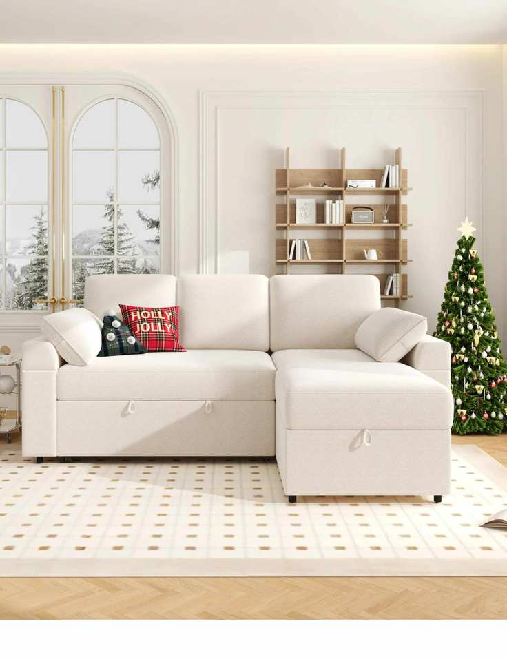 Neutral living room styled for Christmas featuring a large cushion-style sleeper sofa atop of a neutral rug geometric rug