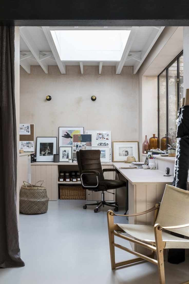 Corner desk in home office with chair and pictures