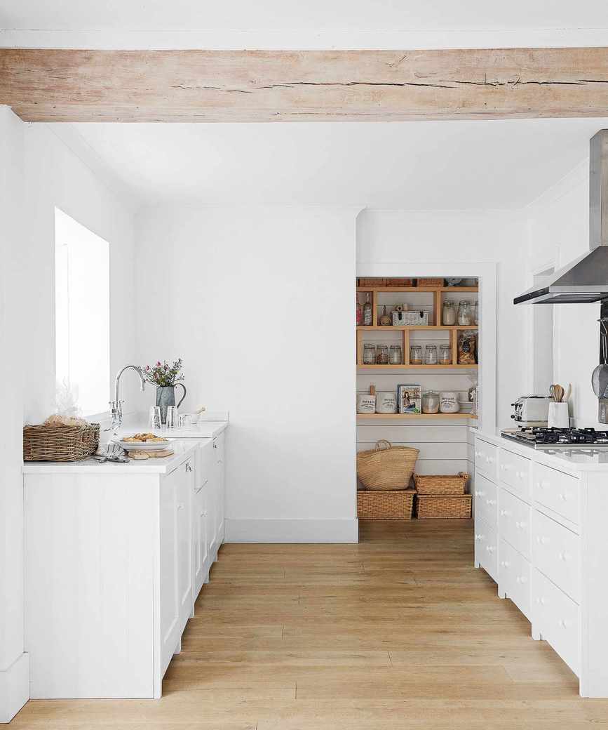 Neat white kitchen with organized pantry