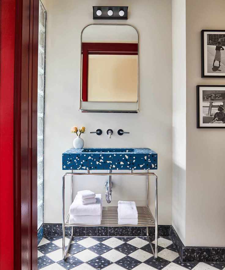 Blue terrazzo sink paired with terrazzo flooring