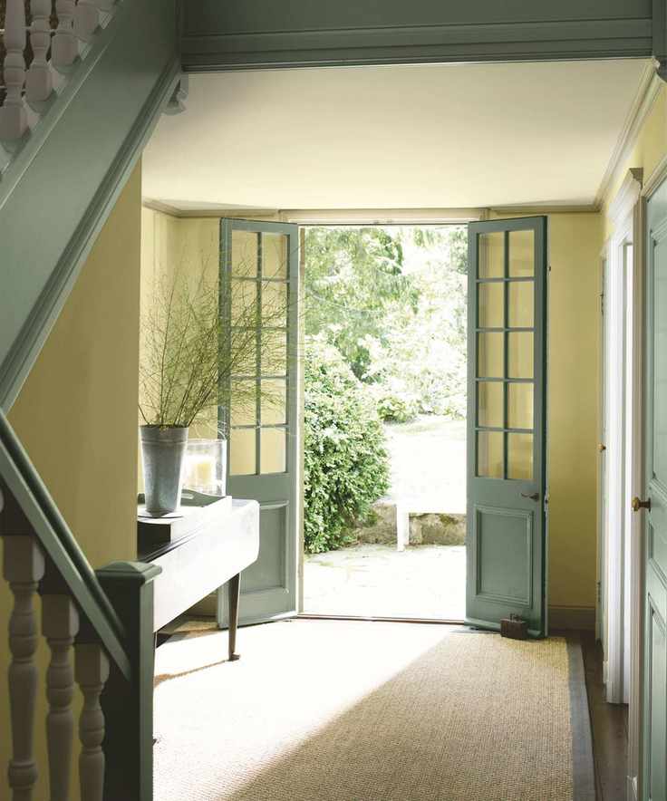 Hallway painted in yellow and green with natural views