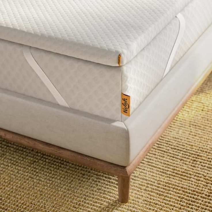Corner of a Nolah Mattress Topper on a bed.
