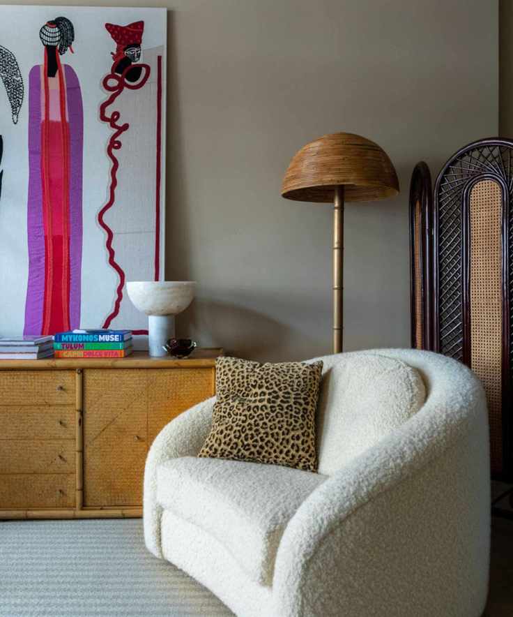 living room with vintage sideboard and boucle armchair