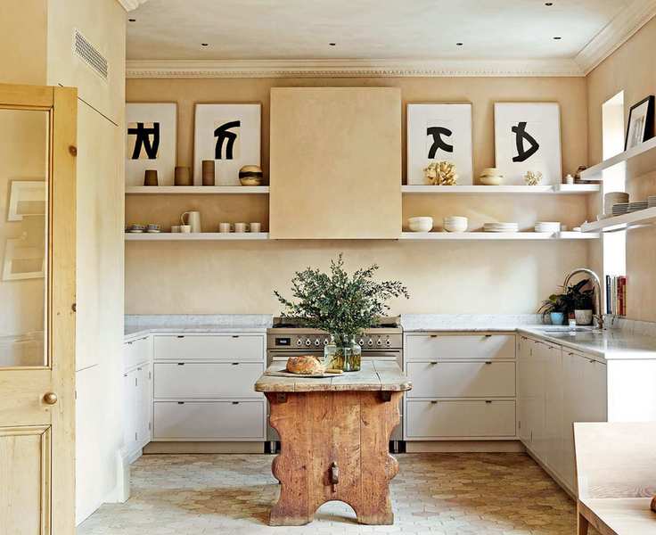 Country kitchen with display above the cabinets and range with central island