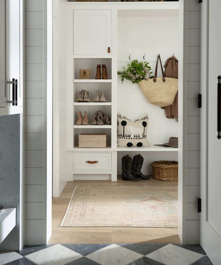 mud room with checkerboard floor pale rug and shelves