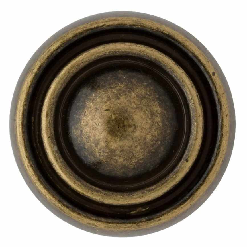 A brass circular door handle