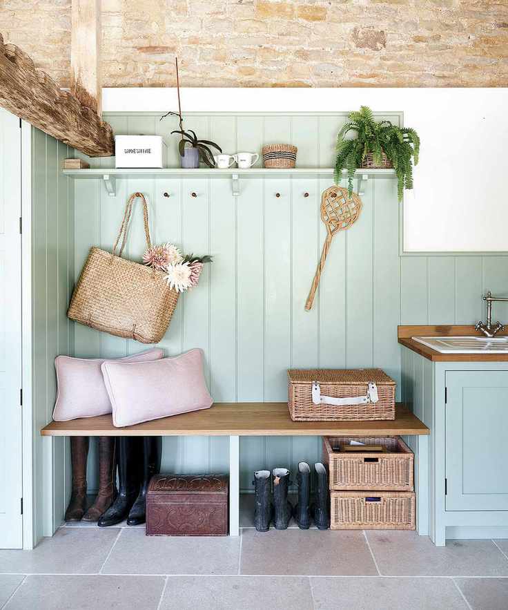 green boot room with exposed stone walls