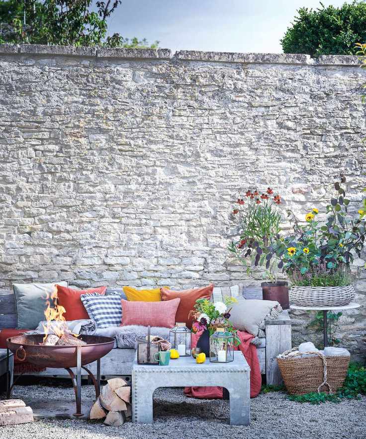 rustic seating area with red and orange cushions