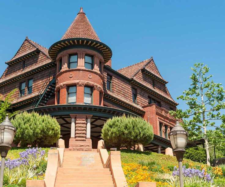An old victorian mansion on the corner of a street