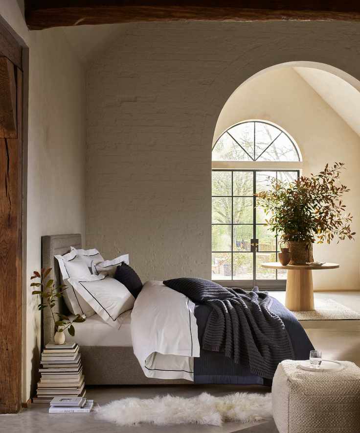Bedroom with cream brick walls and large garden doorway