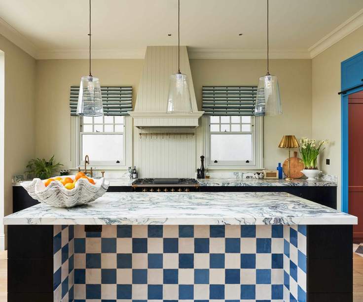 A one wall kitchen with a large island reserved for prep space
