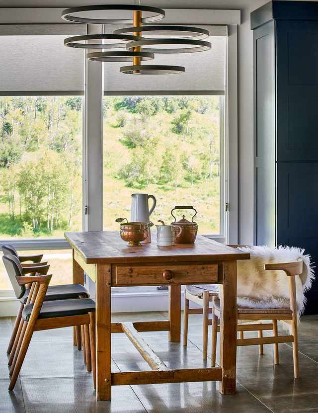 dining room with modern rustic furniture and walls of windows