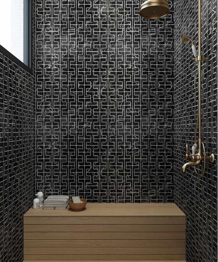 Black Fameed Khalique wet room with wooden bench.