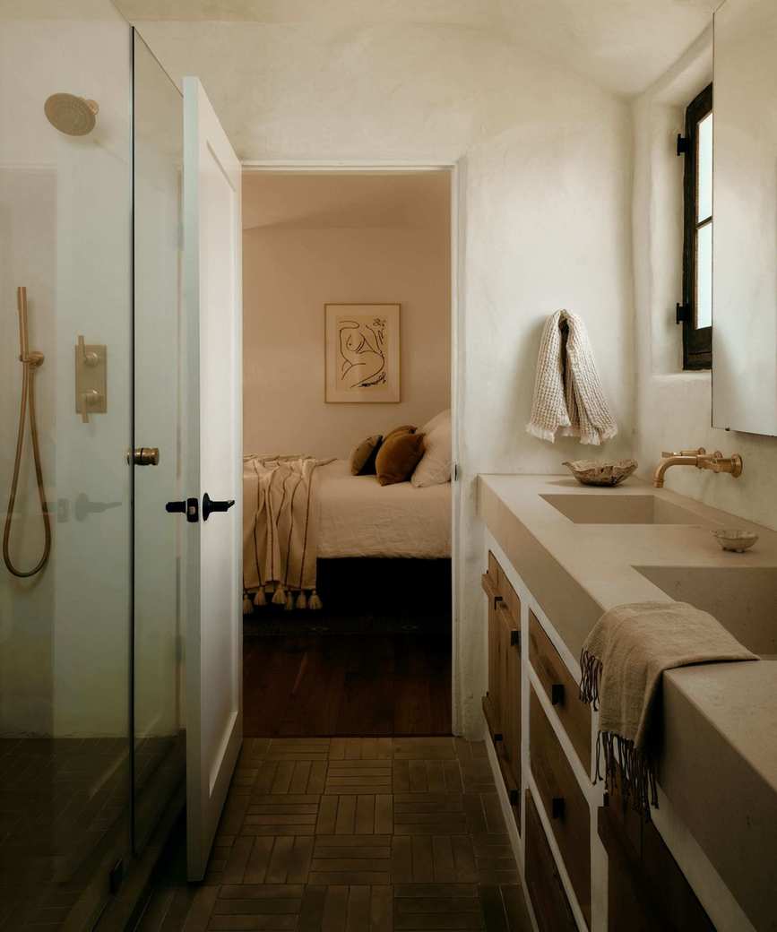 A modern organic bathroom accessible from two bedrooms