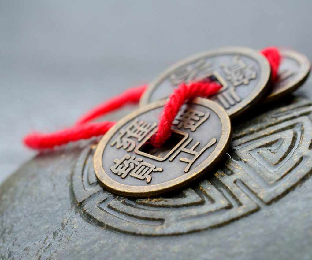 Chinese money ornament on a rock