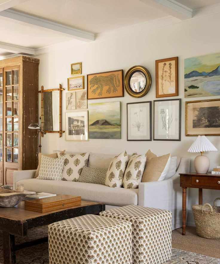 living room with white sofas gallery wall and soft neutral colors and wooden floors