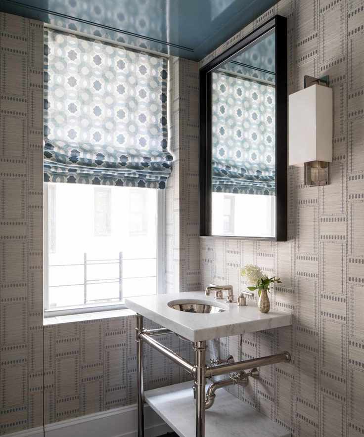 A powder room with high gloss painted blue ceiling and hand stitched taupe wallpaper