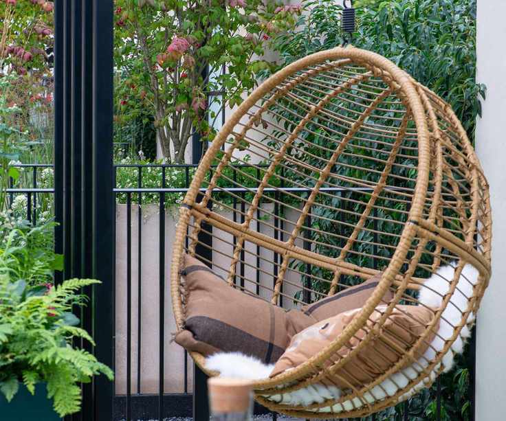 rattan hanging chair on a balcony garden