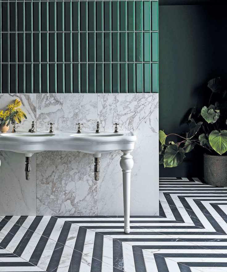 Stylish bathroom with black and white floor tiles and green wall tiles