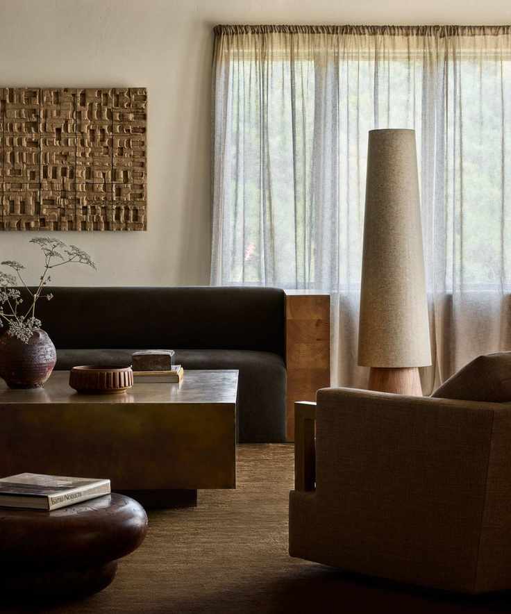 An adobe home living room with wooden furniture and earthy colors