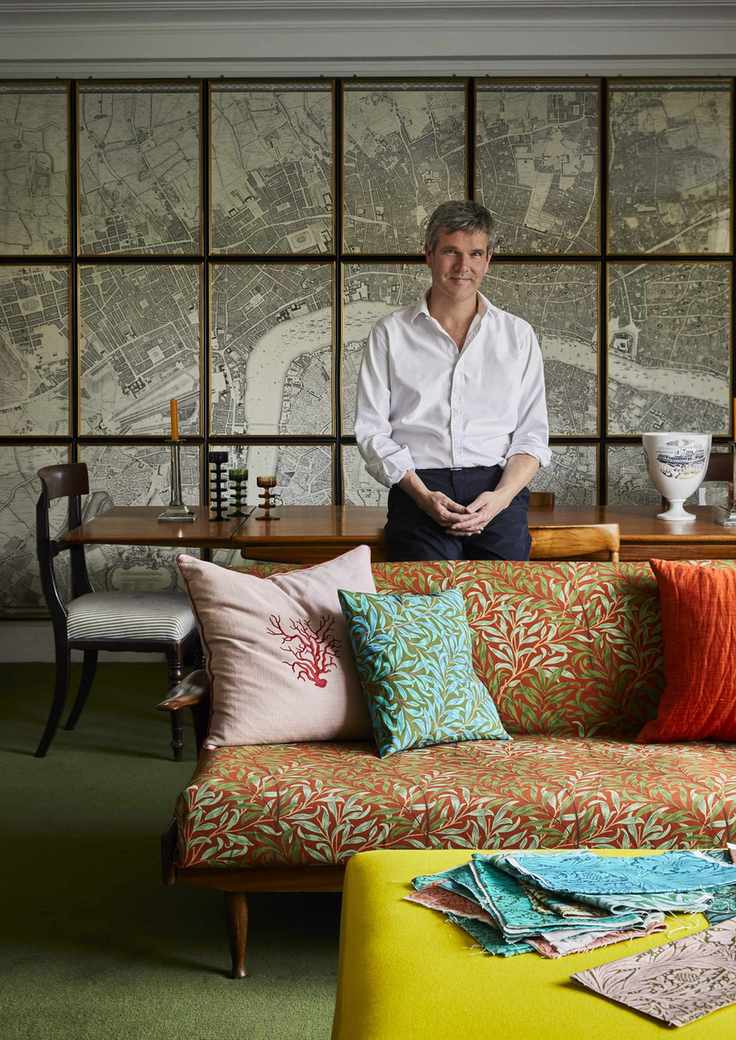 Ben Pentreath in a living room decorated with Morris & Co wallpapers and fabrics