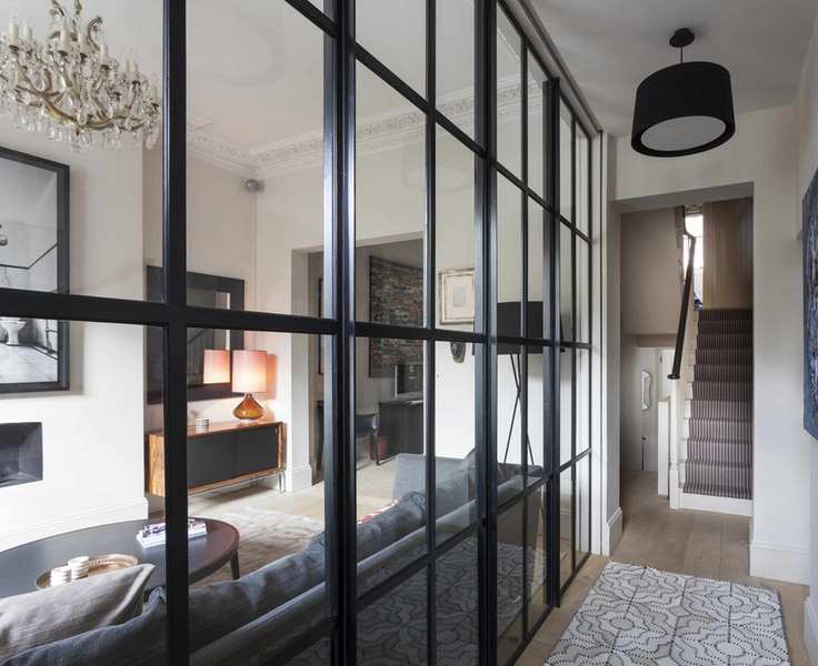 A modern hallway featuring a Crittall wall