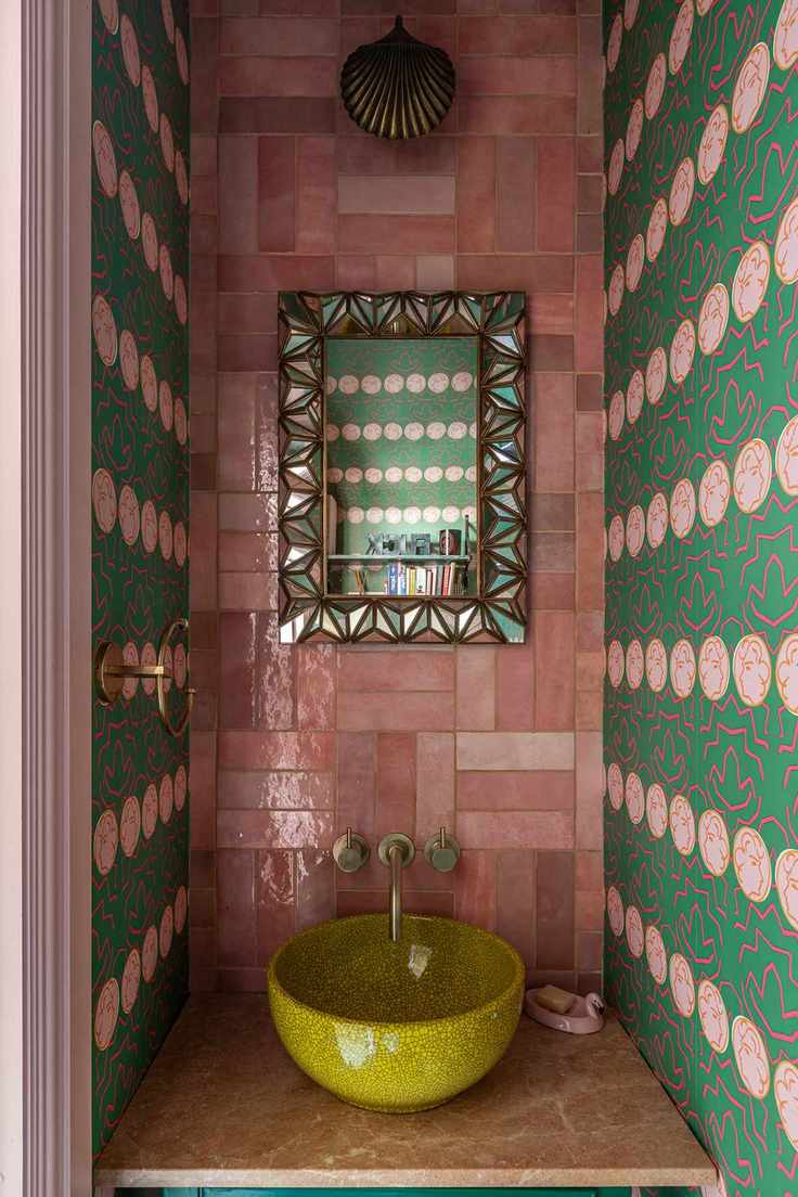 Colorful bathroom with pink tiles and green wallpaper