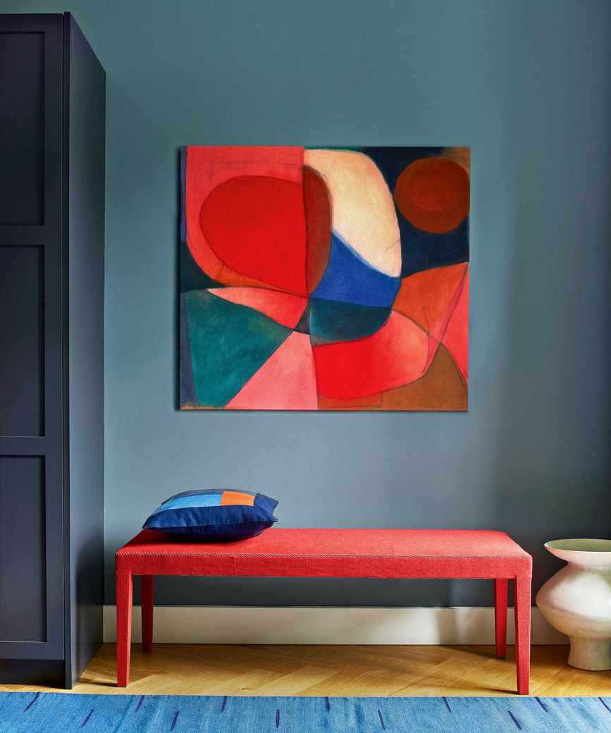 Vibrant hallway with blue walls and a striking red bench