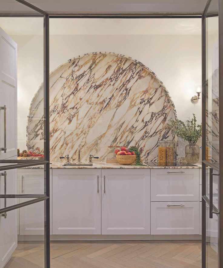 Kitchen with half moon backsplash in marble