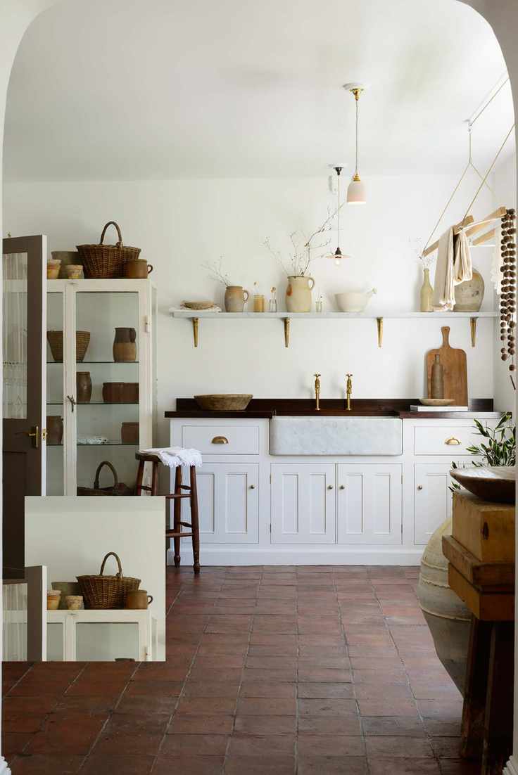 utlity room with terracotta tiles and white butlers sink and cabinetry