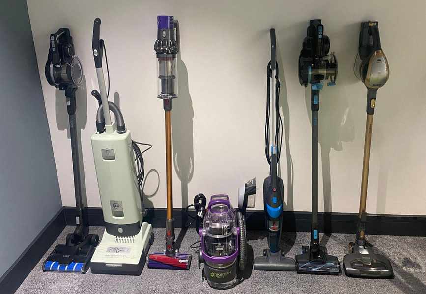 The vacuums which we tested lined up against a wall
