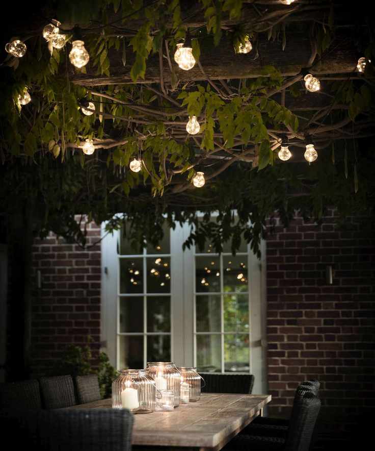 garden table with lanterns and festoon lights
