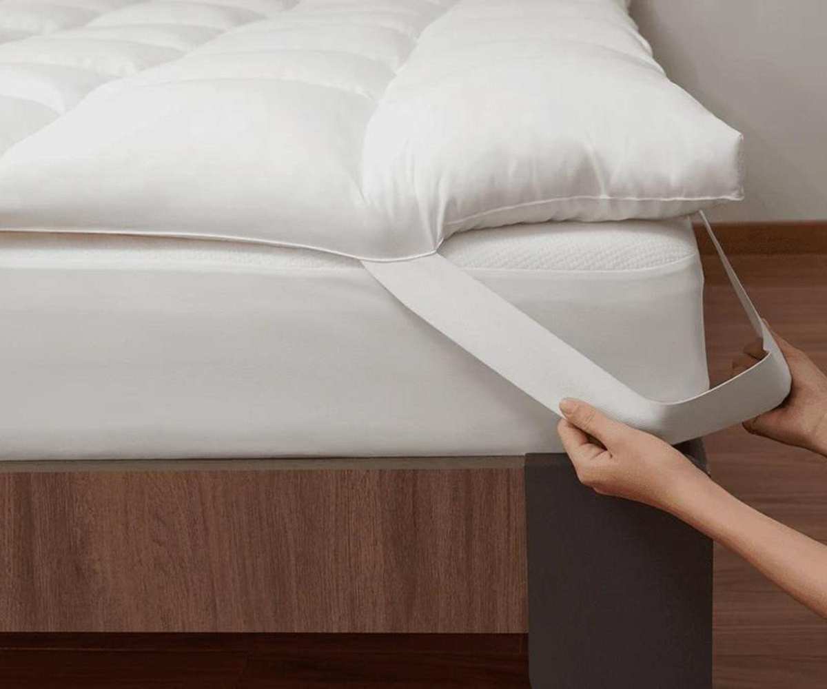 Coop Mattress Topper on a bed.