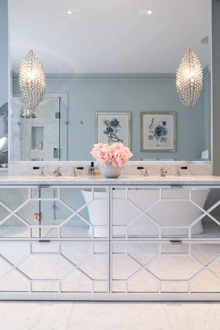 A bathroom with mirrored furniture
