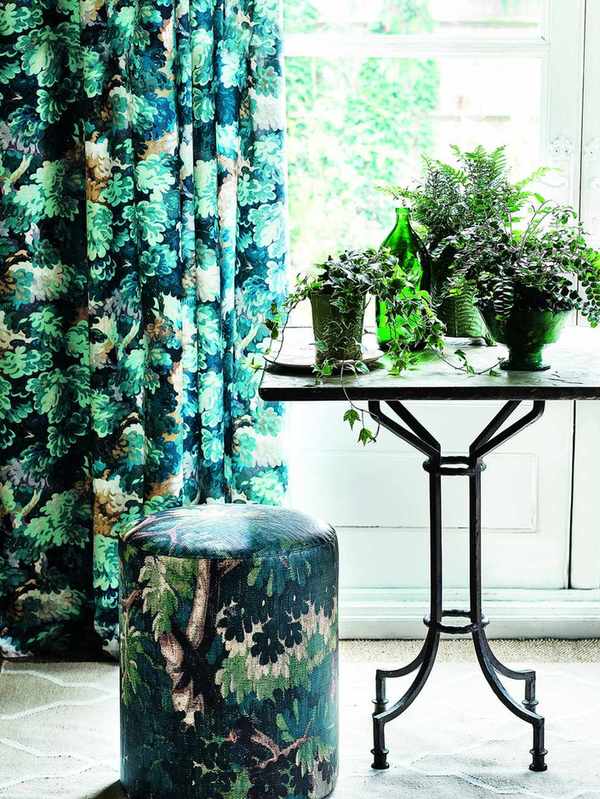 Vintage garden table by a window with a group of potted plants