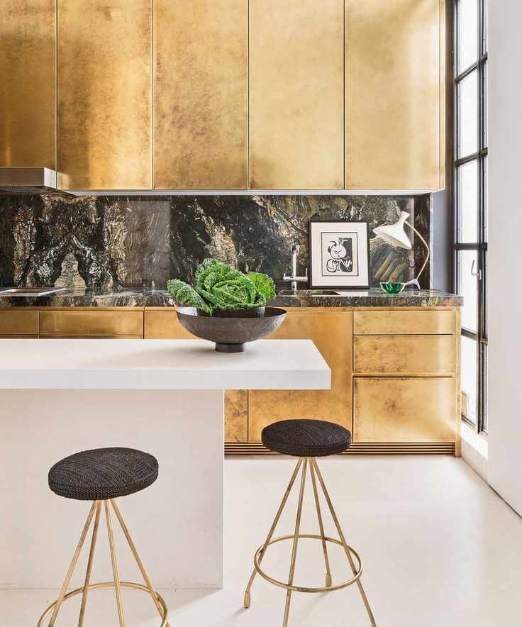 Contemporary kitchen featuring gold cabinetry