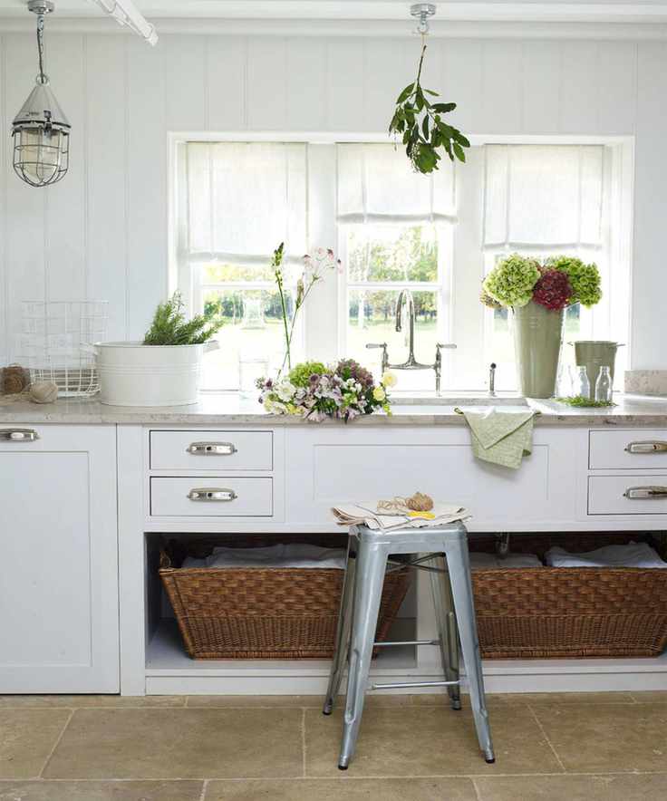 White cabinetry with drawers and storage baskets
